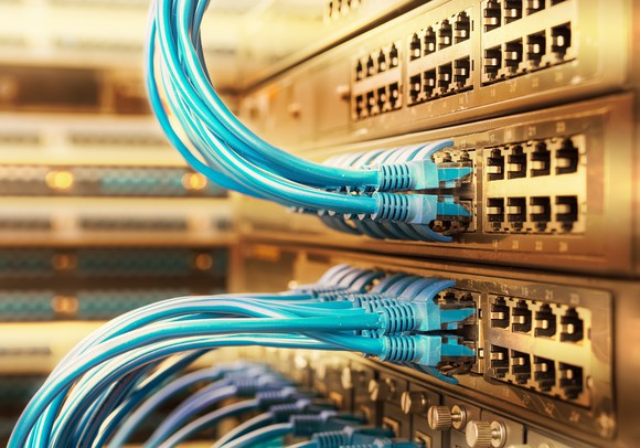 Wires plugged into servers in a data center.