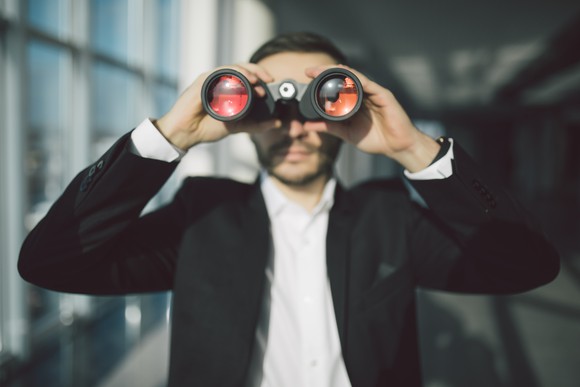 Man looking through binoculars