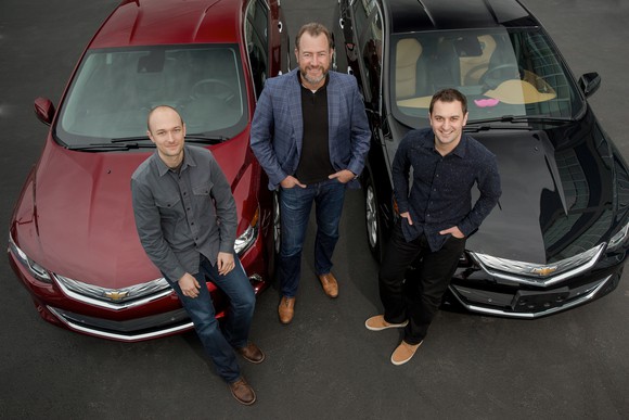 Green, Ammann, and Zimmer with two Chevrolet Volt plug-in hybrid sedans.