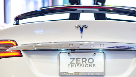 Tesla Model X with a rear license plate reading, "Zero Emissions."