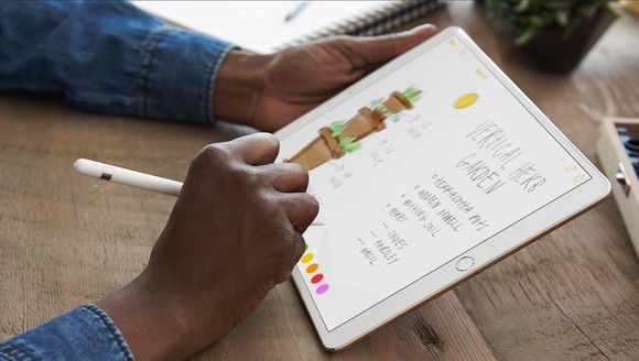 A person using Apple's iPad Pro with an Apple Pencil.