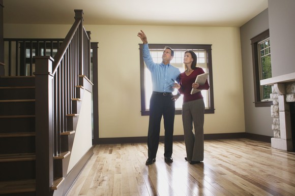 A home inspector walks in a house. A home inspector walks in a house.
