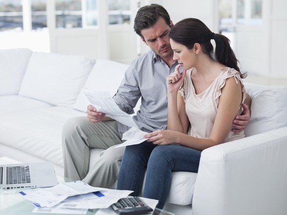 Worried couple looking at healthcare bills