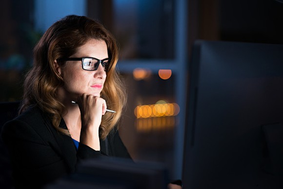 Photo of woman concentrating on her investment alternatives.