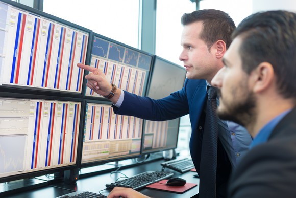 Stock traders looking at computer screens.