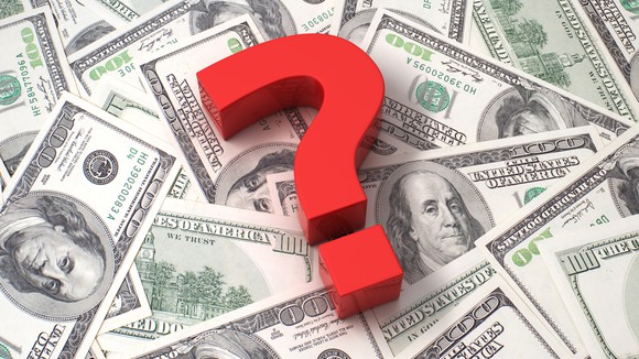 A question mark on a pile of money.