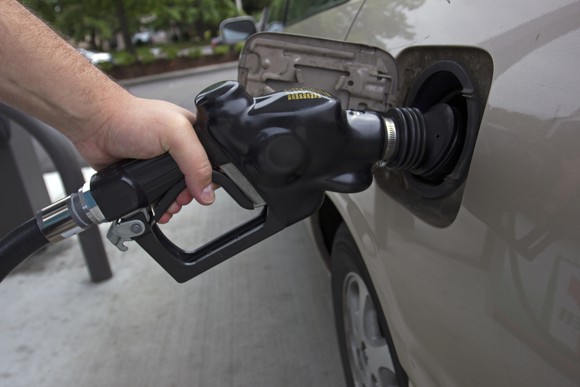 A person pumping gas.