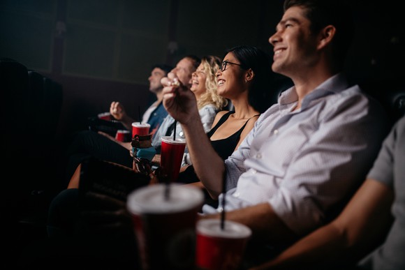 People watching a movie in a theater. People watching a movie in a theater.