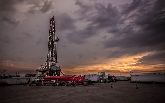 Land drilling rig at sunset