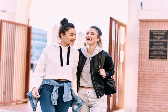 Two smiling teenagers are shown outdoors, wearing Charlotte Russe fashions.