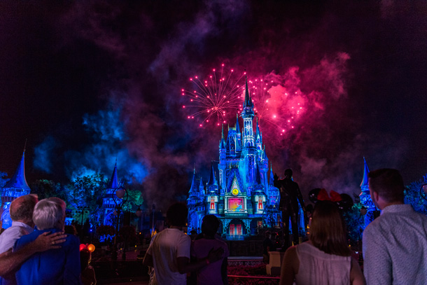 Onlookers enjoy the nightly Walt Disney World fireworks display over Cinderella Castle.