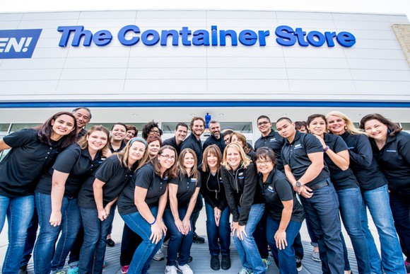 A group of Container Store employees in front of a store