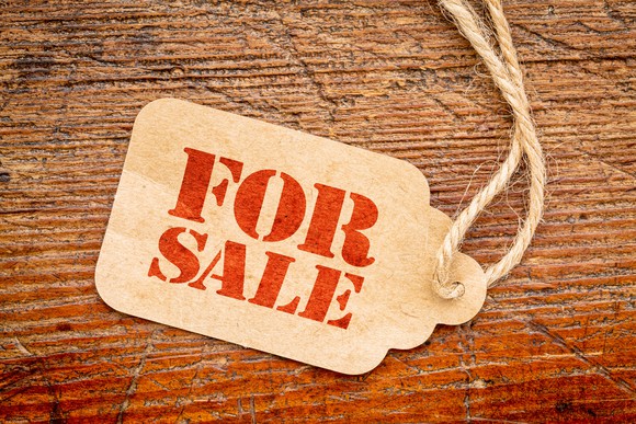 A "FOR SALE" tag rests on a display table.