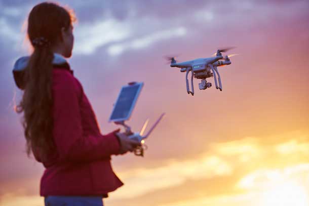 Image of a girl flying a drone.