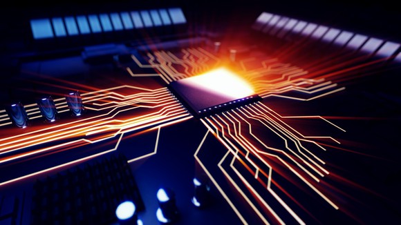 Illuminated circuits branch out from a computer chip.