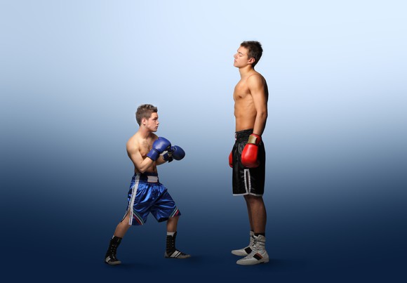 A small boxer taking on a much larger opponent.