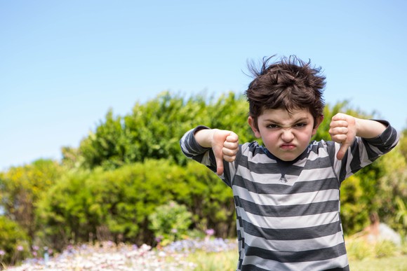 A kid with two thumbs down.