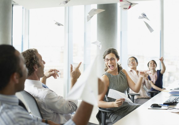 Business people throwing paper airplanes