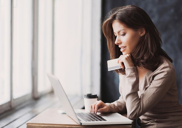 Woman shopping online with a credit card.