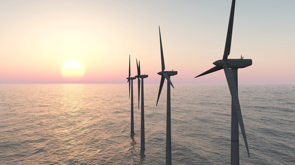 Offshore wind turbines at sunset.