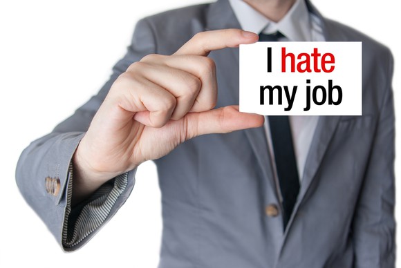 Man holding card stating "I hate my job"