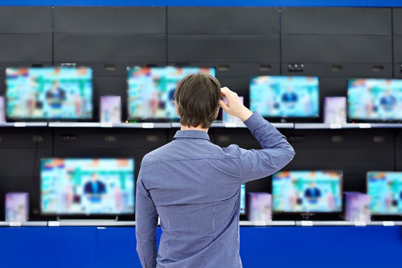 Man shopping for a TV.