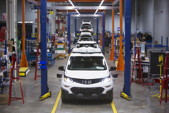 Chevrolet Bolts with self-driving hardware move down an assembly line at a GM factory in Orion Township, Michigan.
