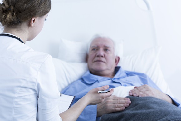 Senior male patient talking to a nurse