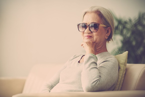 senior woman wearing sunglasses while sitting