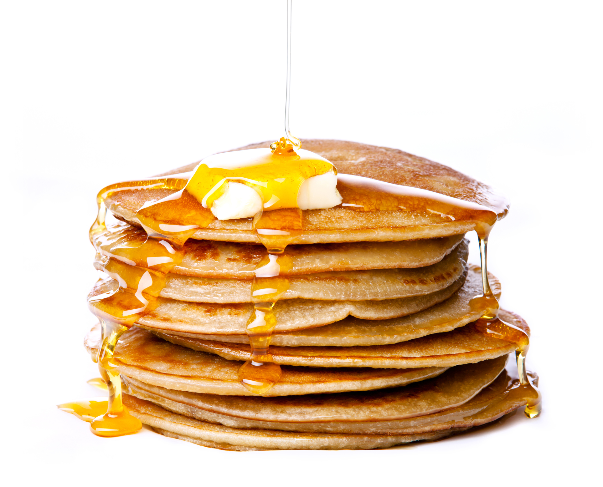 Pancakes with syrup drizzling over it.