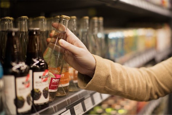 Person grabbing a drink at an Amazon Go checkout-free store