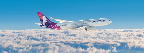 A Hawaiian airplane, flying above the clouds.