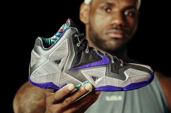 LeBron James holding his latest shoe design.