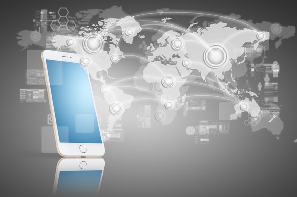 Smartphone on map of global connections.