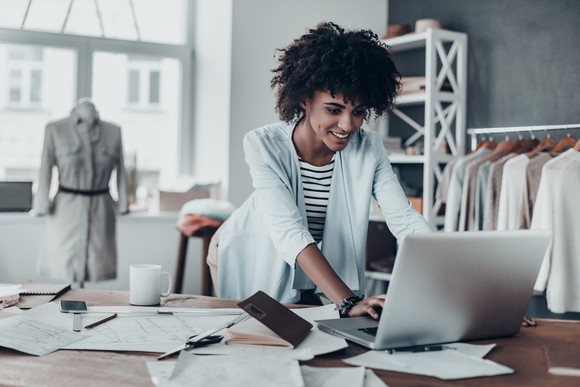 Woman working on a laptop.
