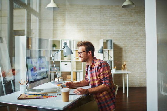 Man working on an office computer.