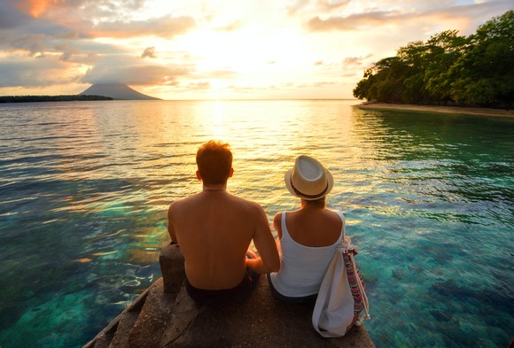 Couple watching an ocean sunset.