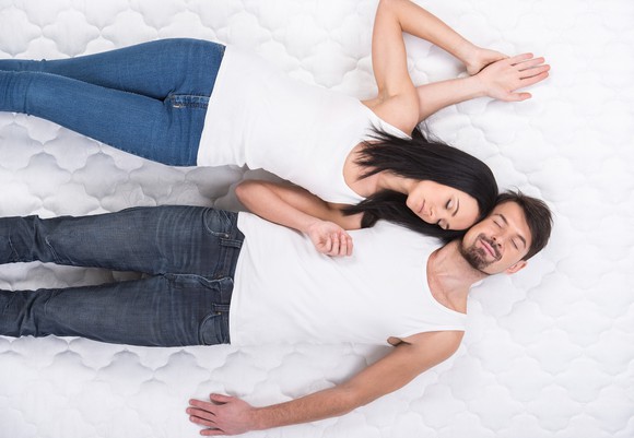 Couple laying on a mattress