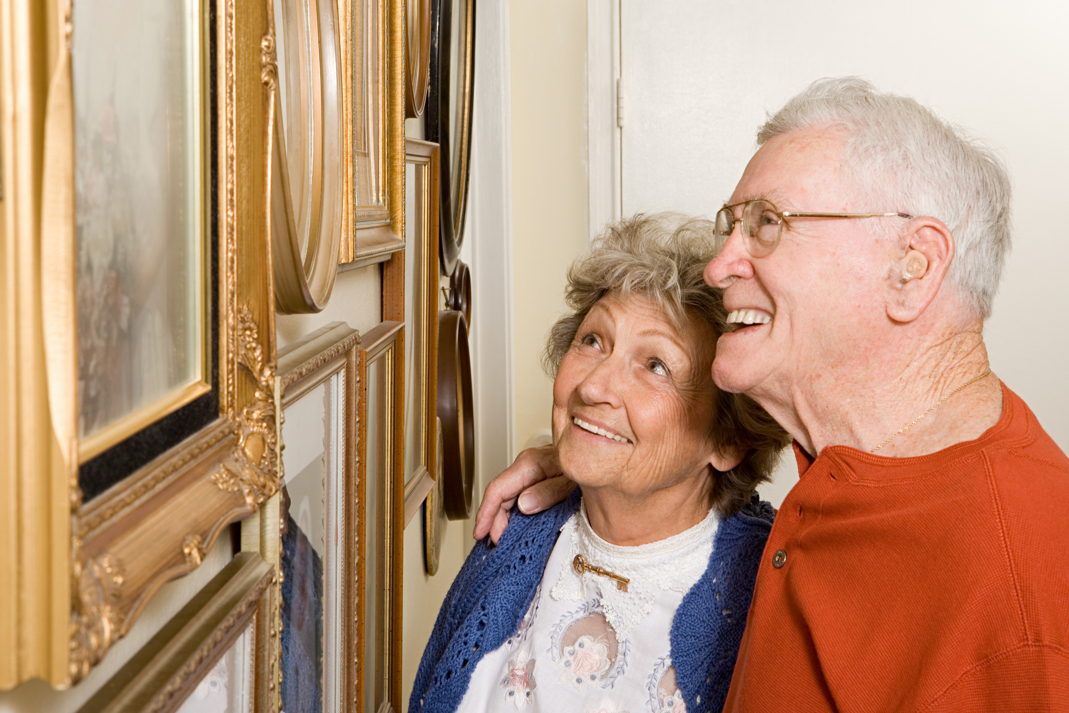 Retired couple looking at framed artwork