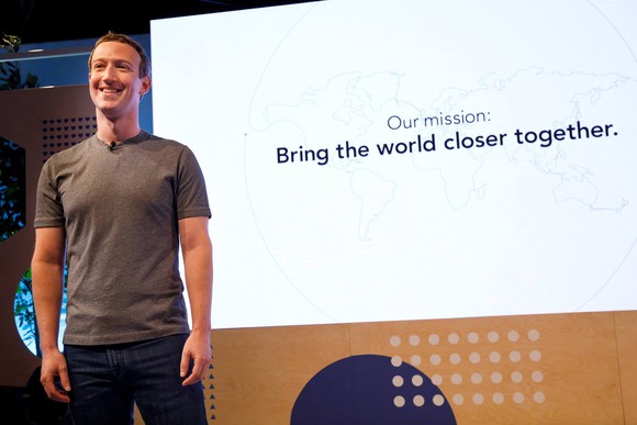 Facebook CEO Mark Zuckerberg standing on stage to reveal the social network's new mission statement.