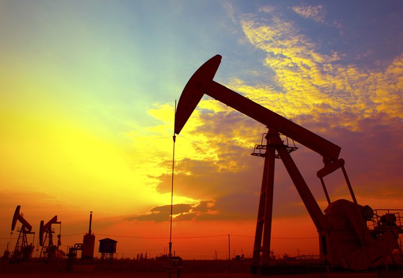 An oil derrick at sunset.