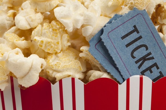 close up of two tickets stubs in a box of popcorn.