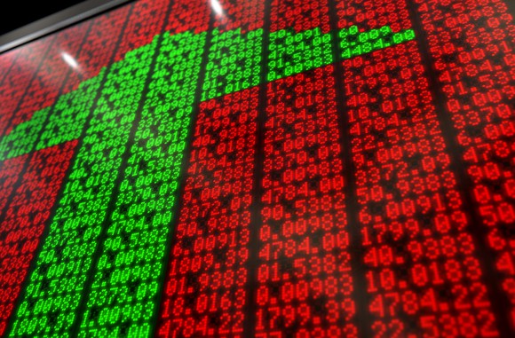 A flat section of a digital stock market-indicator board with green numbers making an upward-facing arrow.