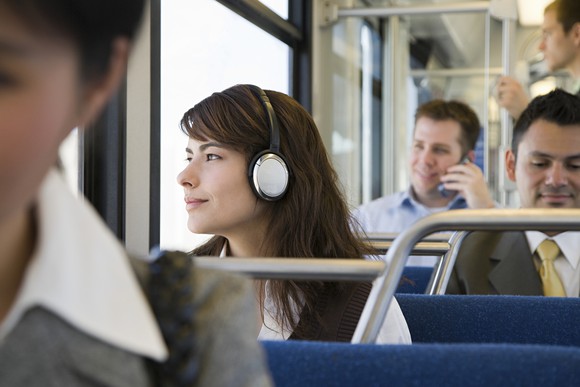 Woman with headphones, commuting