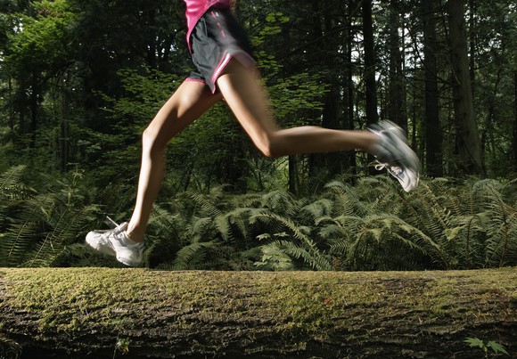 A jogger running through the woods.