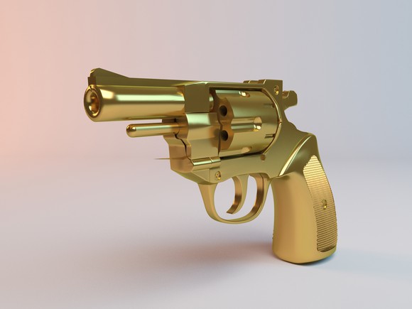 A close-up of a golden pistol.