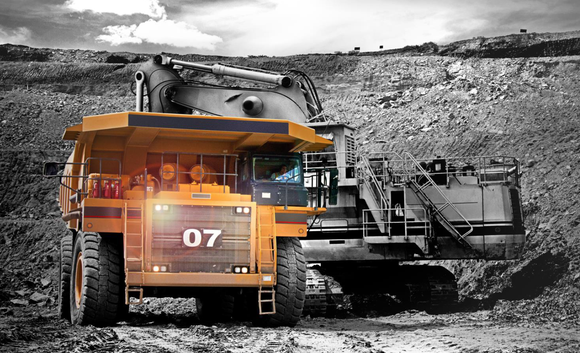 A large truck highlighted in gold and a black and white background.