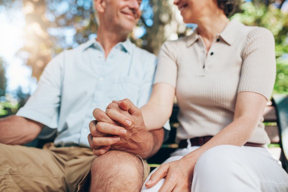 Senior couple holding hands