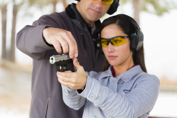 A woman receiving firearms training.