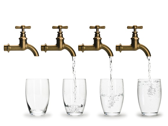 A row of faucets filling up glasses of water.